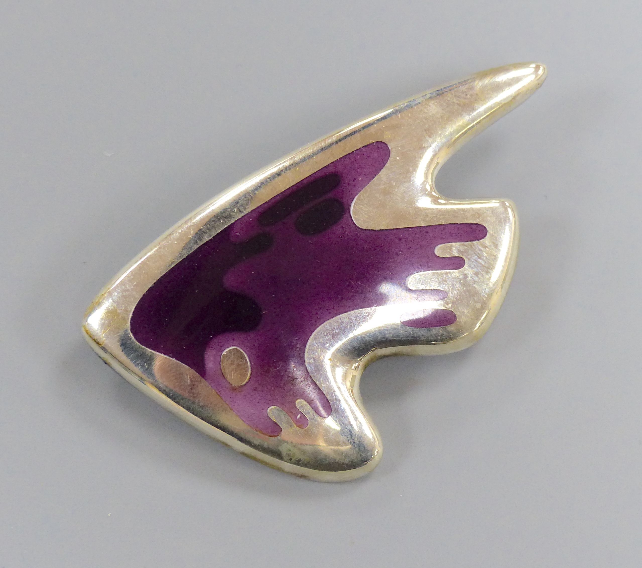 A George Jensen sterling and two colour purple enamel stylised fish brooch, designed by Henning Koppel, no. 307, 61mm.
